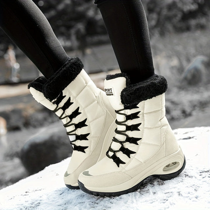 Pair of cream platform boots with black plush collars, worn while walking