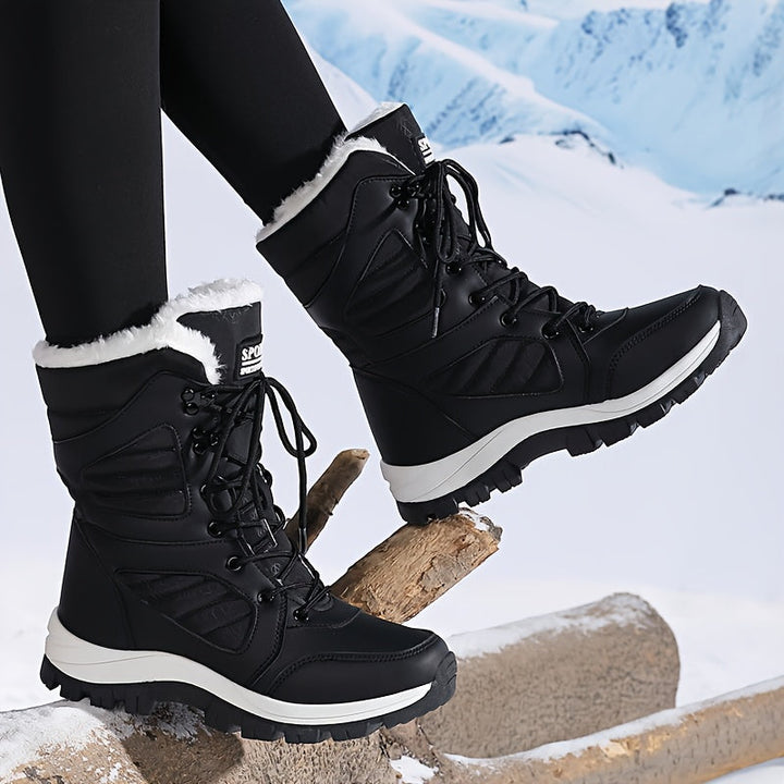 Black lace up boot stepping onto a log in a snowy setting