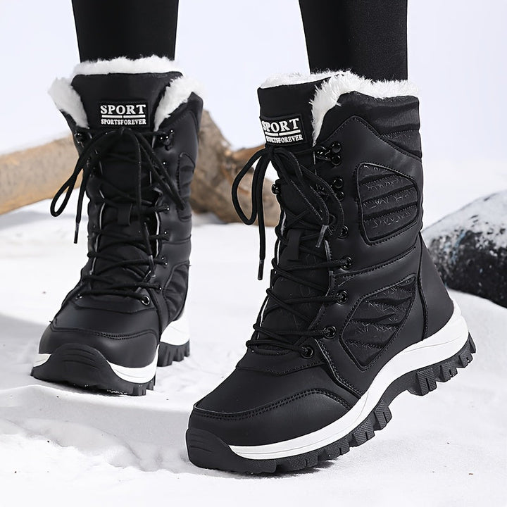 Black lace up mid calf boots with white sole walking in snow