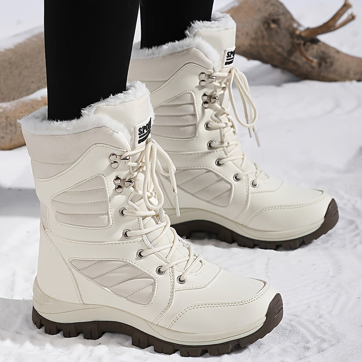 Cream fur collar boots worn outdoors with black leggings in the snow