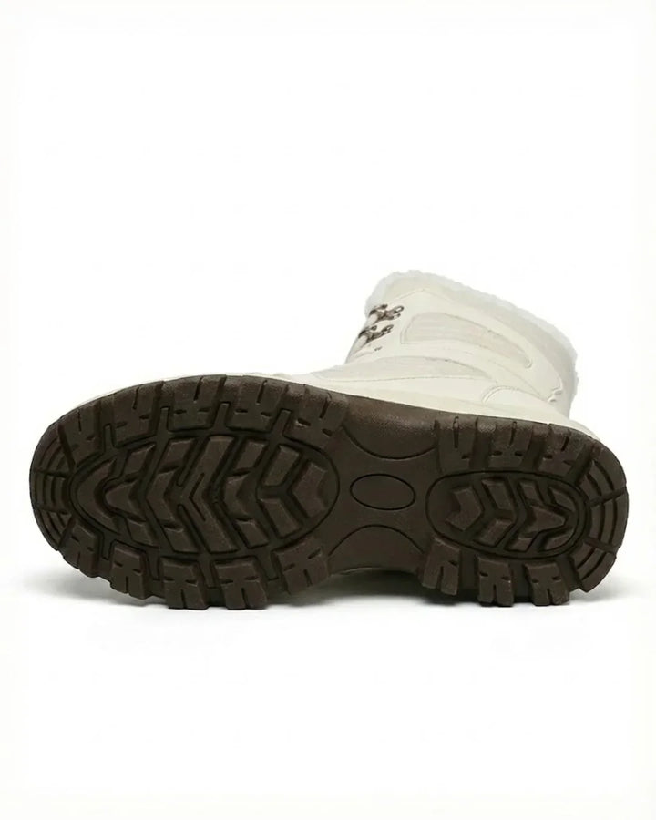 Cream boot turned to show the deep tread of the brown lug sole