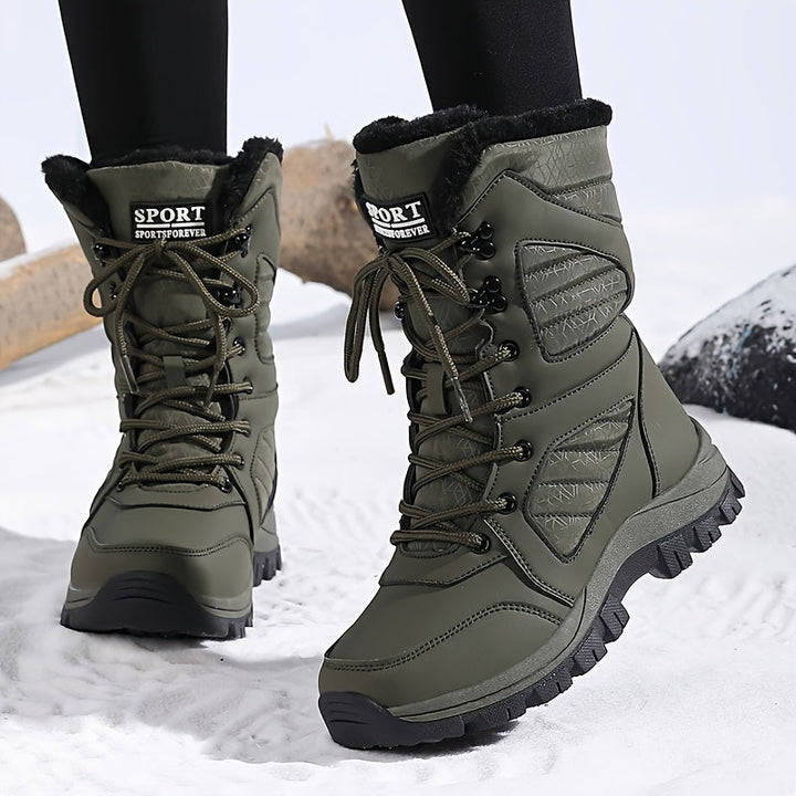 Olive boots with lug sole worn with black leggings in the snow