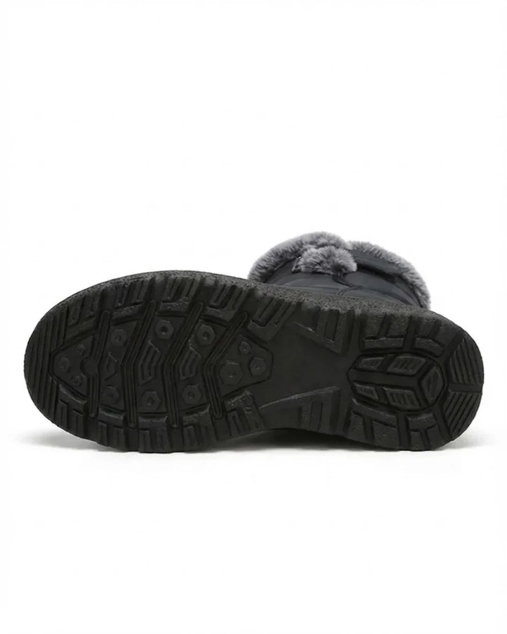 Underside of the black boot showing the deep treaded rubber sole
