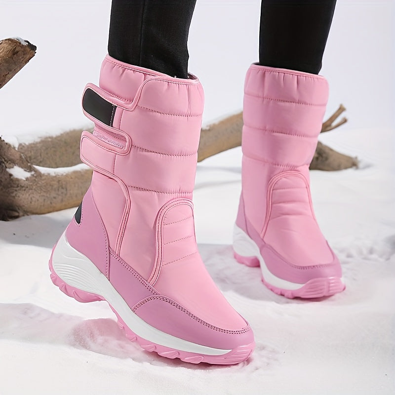 Pink quilted double strap boots with a thick white sole on snow