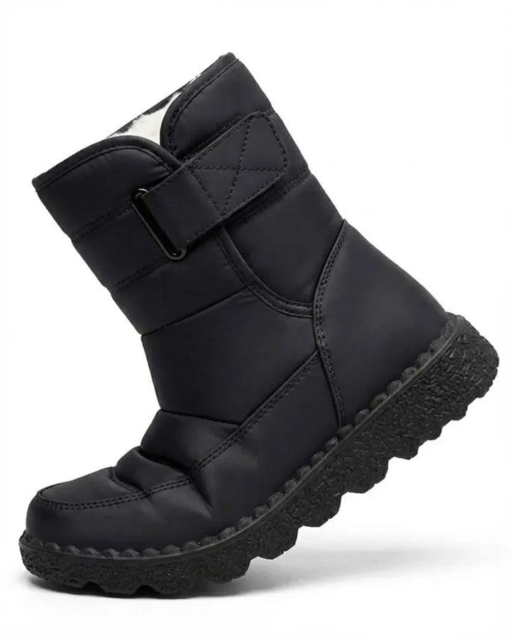 Black quilted pull on boot with wide hook and loop strap, angled view