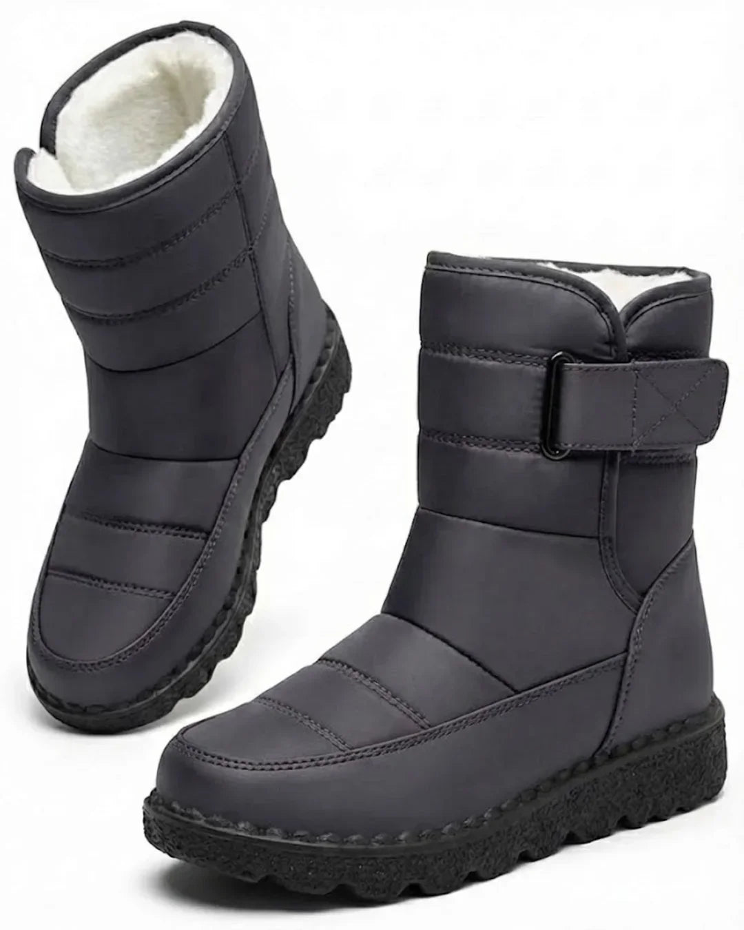 Pair of gray quilted mid calf boots with a wide strap
