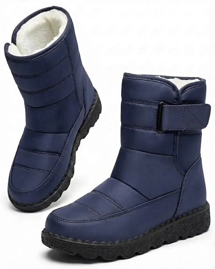 Pair of navy quilted mid calf boots with a wide strap