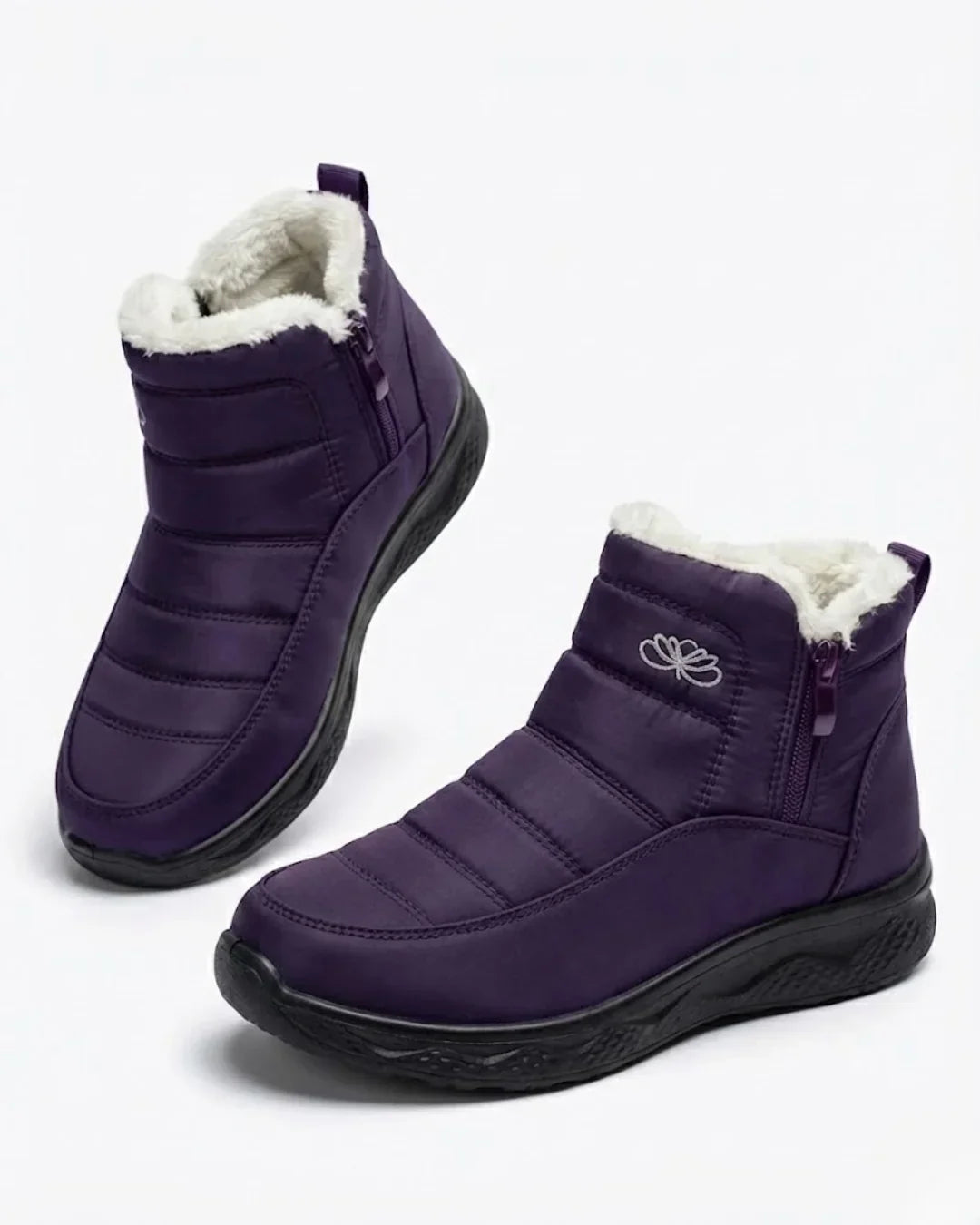 Pair of purple quilted ankle boots with side zip and plush collar