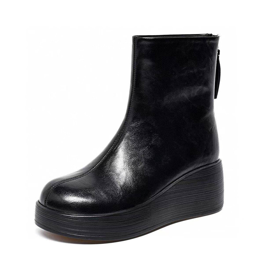 Black platform wedge ankle boot with back zip on a white background