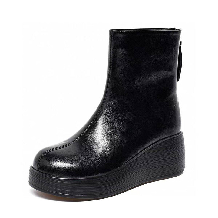 Black platform wedge ankle boot with back zip on a white background