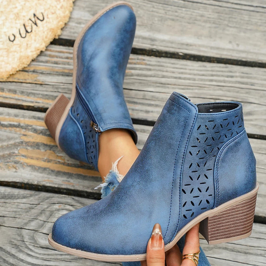 Blue western ankle boot side view with perforated pattern and block heel