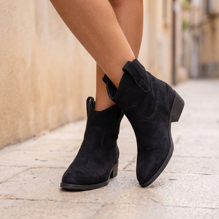 Side view of black western ankle boots with a slightly pointed toe