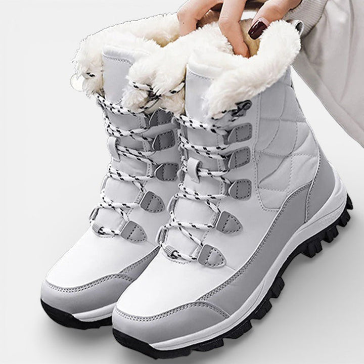 Pair of white winter boots with gray laces and plush trim