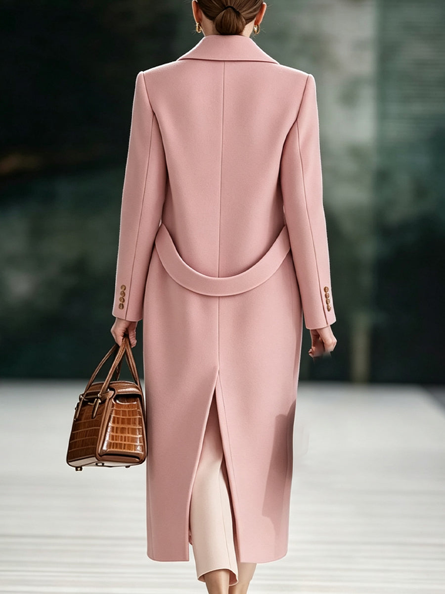 Back view of the pink coat with half belt at the waist and center vent