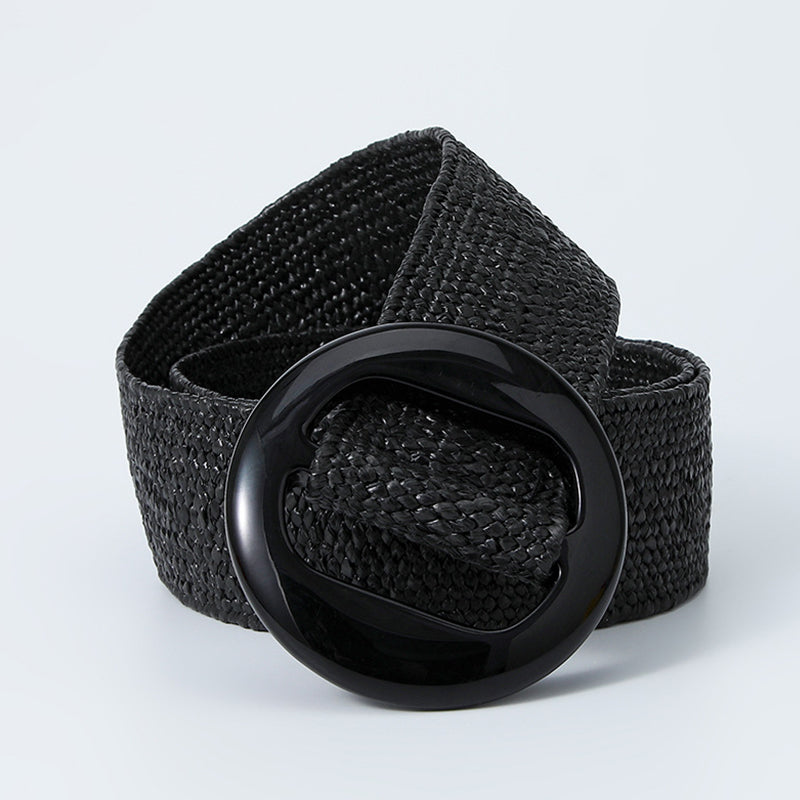 Black woven belt coiled with the glossy round buckle in front