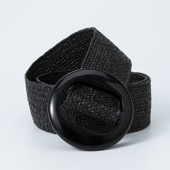 Black woven belt coiled with the glossy round buckle in front