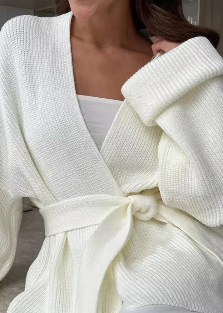 Close view of the ivory rib knit, deep V front and knotted belt