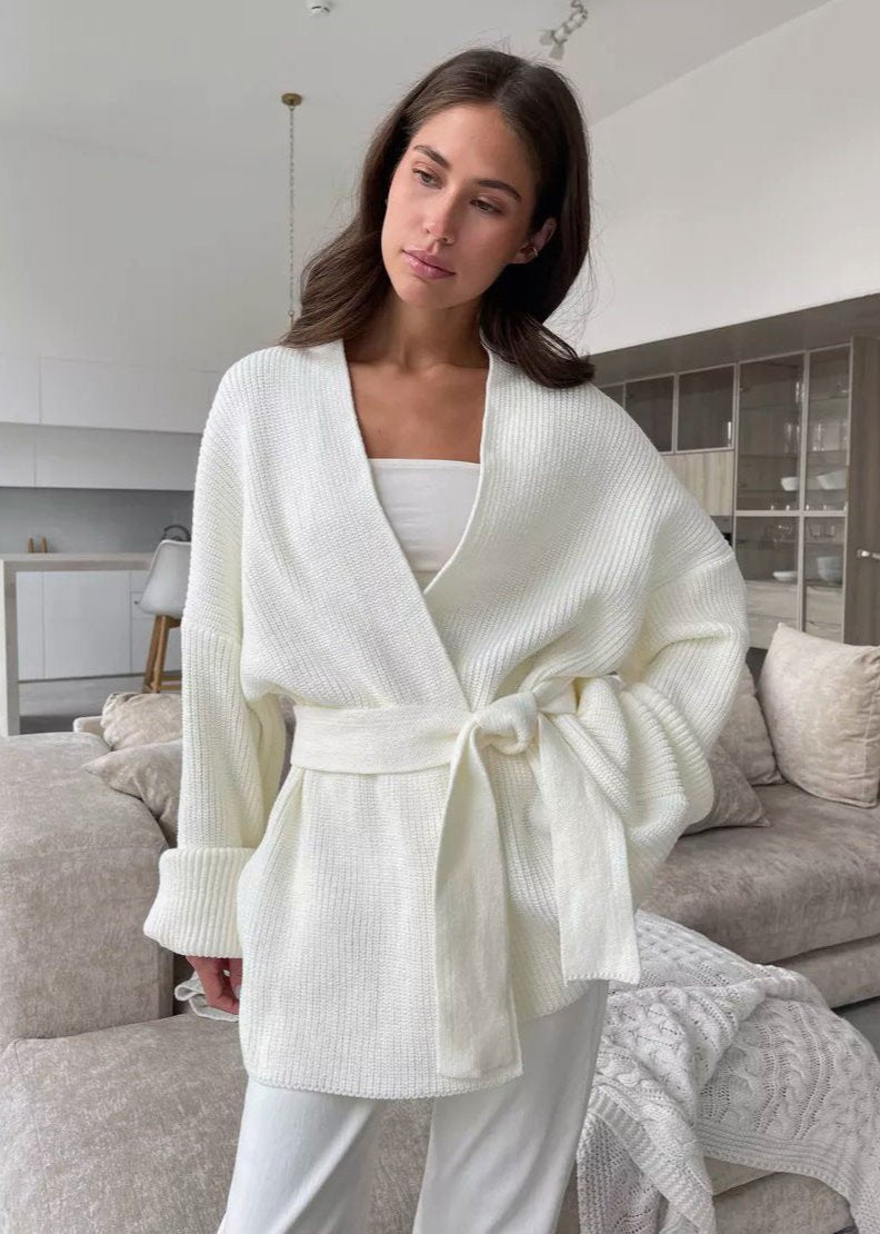 Ivory oversized wrap cardigan with tie belt worn over white pants